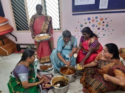 Teachers prepare sweet pongal at the centre